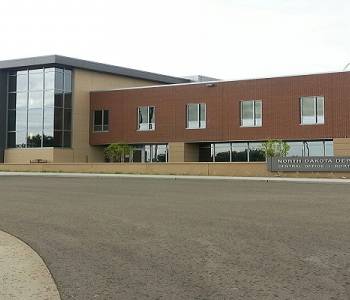 Central Office brown brick building adjacent to the North Dakota State Penitentiary.