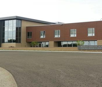 Central Office brick building with glass windows.